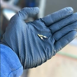 Technician holding a failed component removed from an air conditioner during a repair